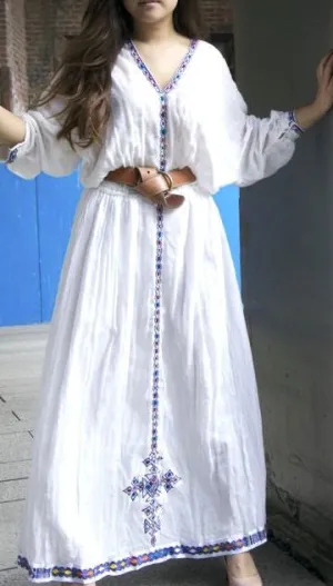 White, long sleeved traditional Ethiopian dress with blue and red cross embroidered motif